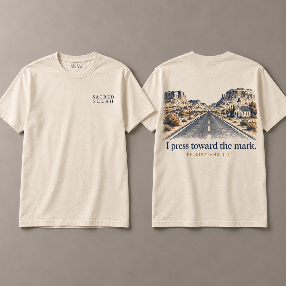 Bone t-shirt, front and back: Sacred Selah on the chest; on the back an open road past a small white church toward mesas and I press toward the mark, Philippians 3:14.