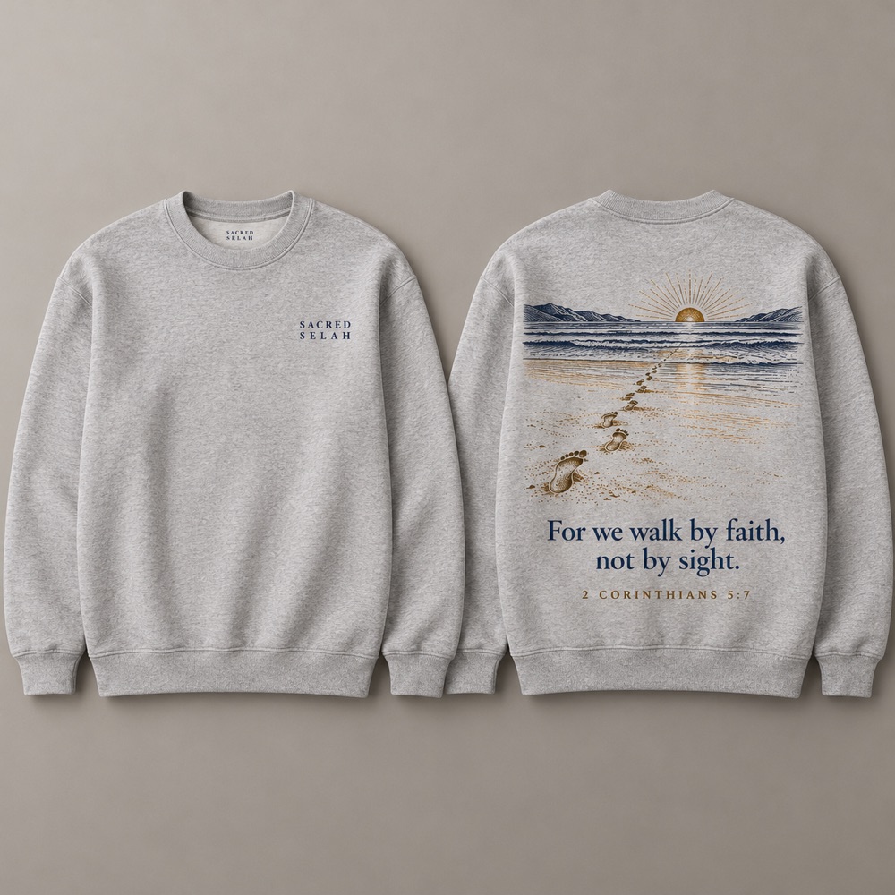 Heather-gray crewneck sweatshirt, front and back: Sacred Selah on the chest; on the back footprints across the sand toward a low sun and For we walk by faith, not by sight, 2 Corinthians 5:7.