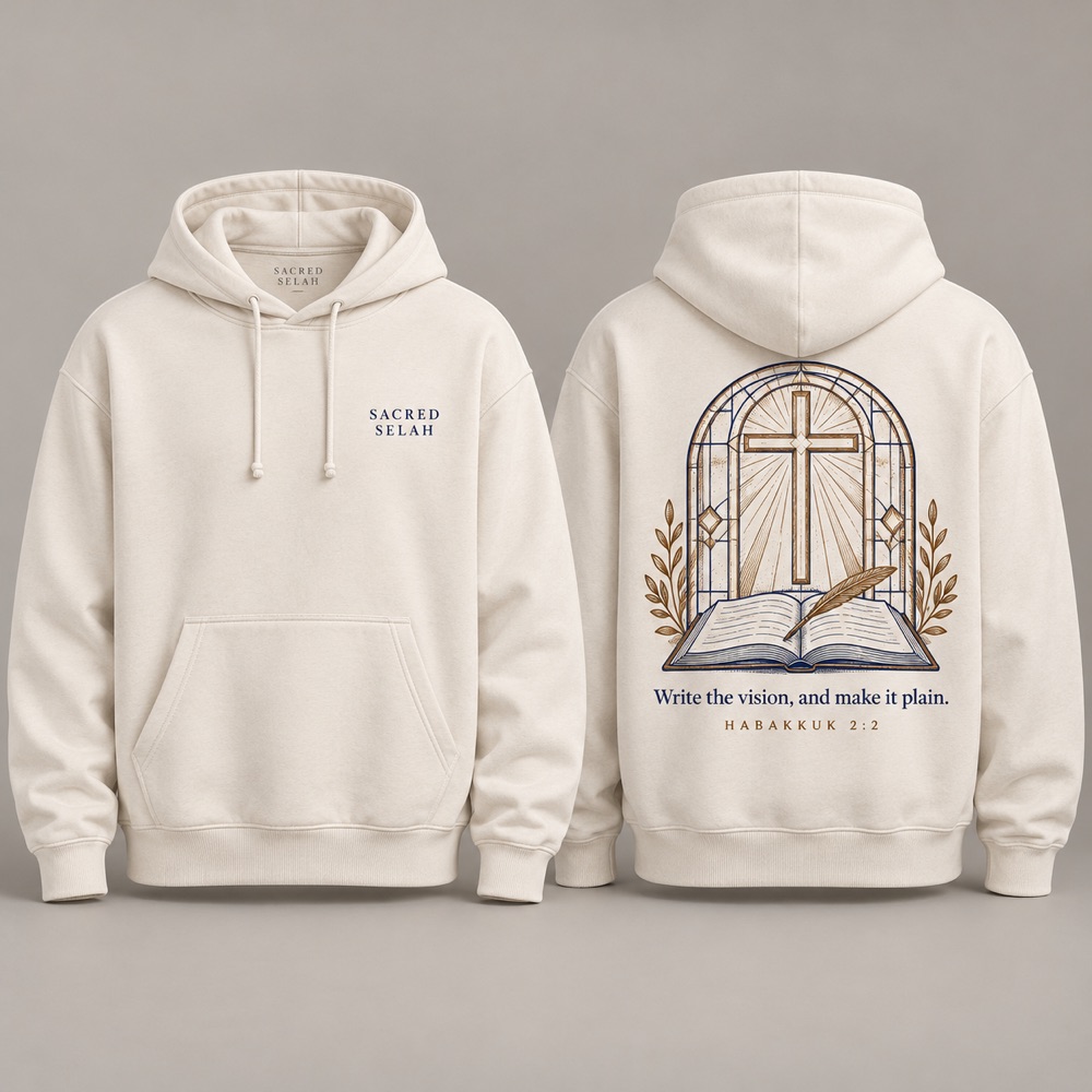 Bone pullover hoodie, front and back: Sacred Selah on the chest; on the back a stained-glass cross above an open book and quill and Write the vision, and make it plain, Habakkuk 2:2.